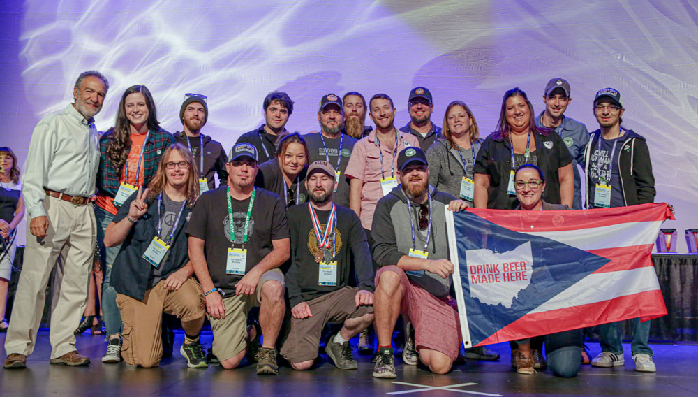 Brewers Association President-Emeritus Charlie Papazian (left) with medal winners of the 2019 GABFl® competition (photo ©Brewers Association)