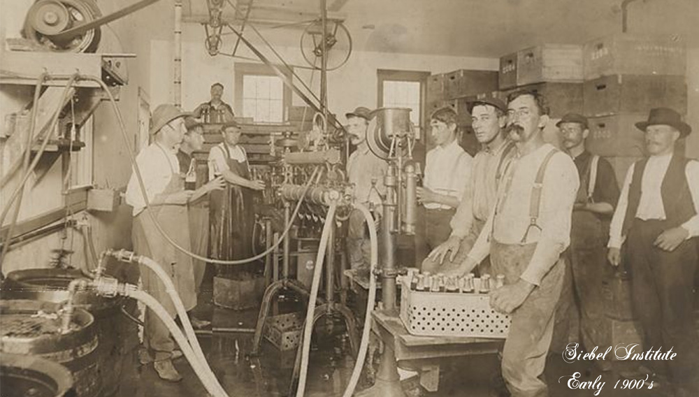 Black and white picture of several people working with brewery equipment at Siebel in the 1900s (Photo: The Siebel Institute)