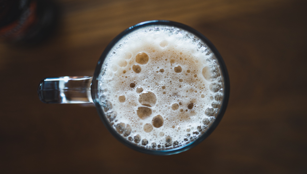 Beer glass with foam viewed from above (Photo: Parker Johnson on Unsplash)