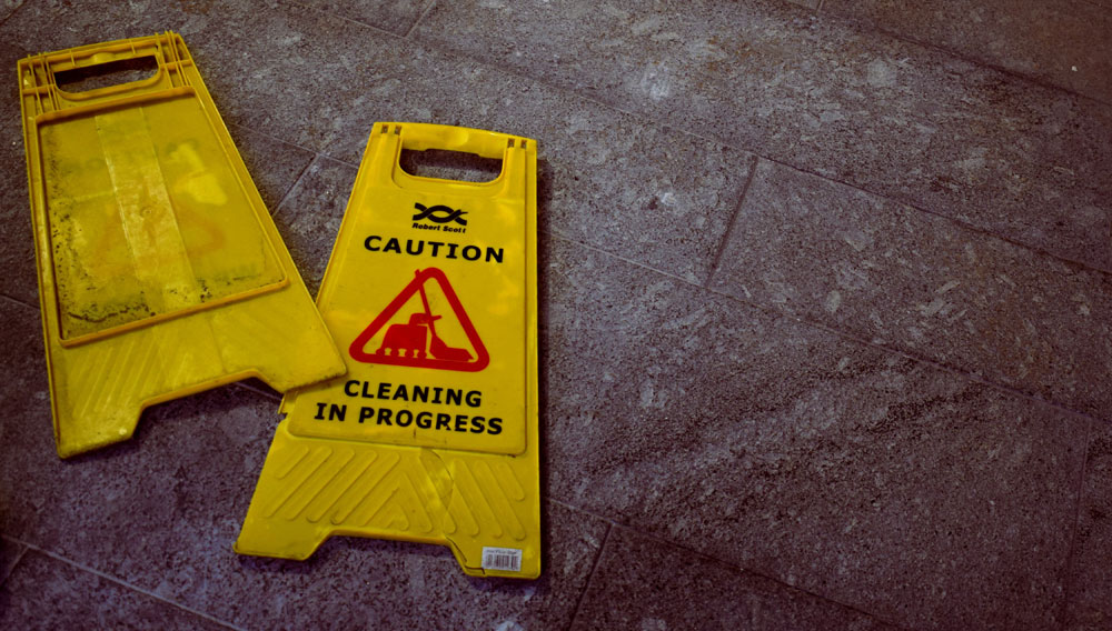 Warning sign saying “Cleaning in progress” (Photo: Oliver Hale on Unsplash)