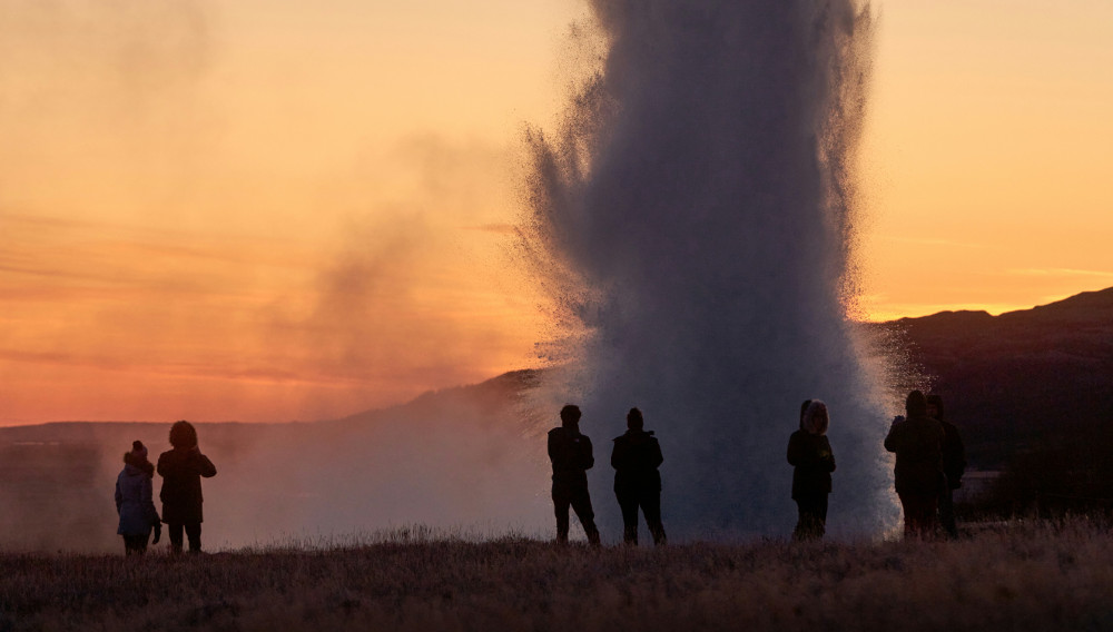 People standing around a geyser (Valdemaras D on Unsplash 2024)