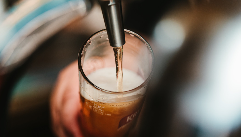 Beer flowing from the tap into a beer glass(Photo: Bence Boros on Unsplash)