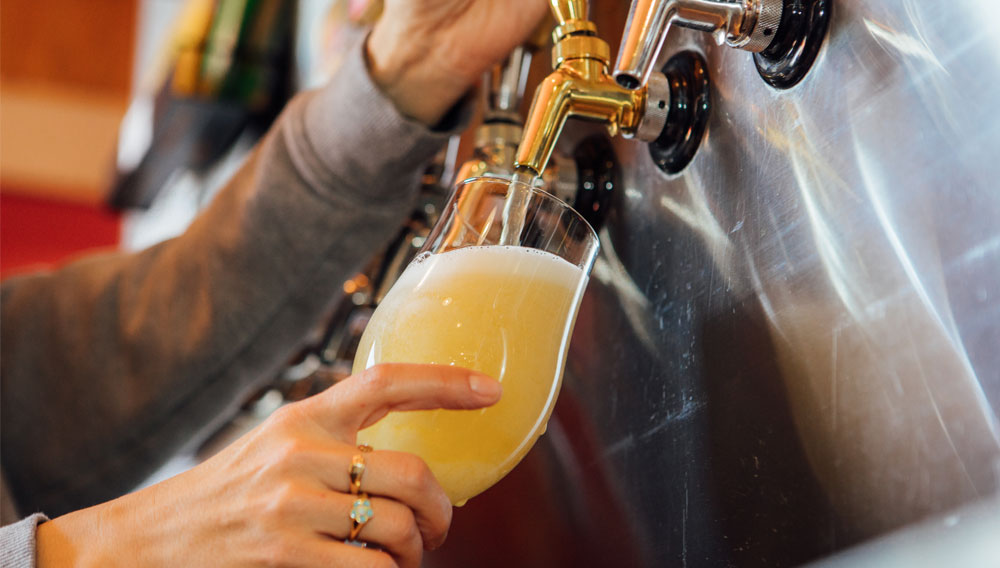 Person pouring an IPA straight from the tap into a glass (Photo: Brewers Association)