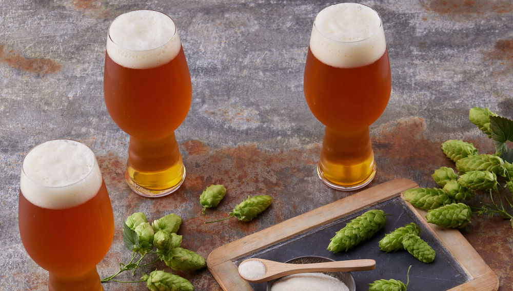 Three beer glasses and hop cones (Photo by Kalsec)