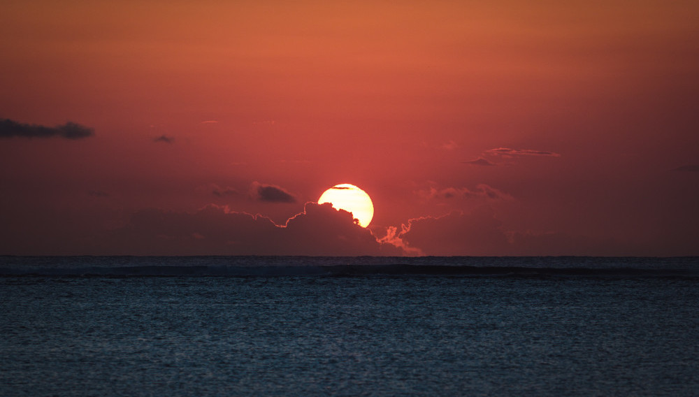 Sunset and calm water (Photo by Jörg Angeli on Unsplash)