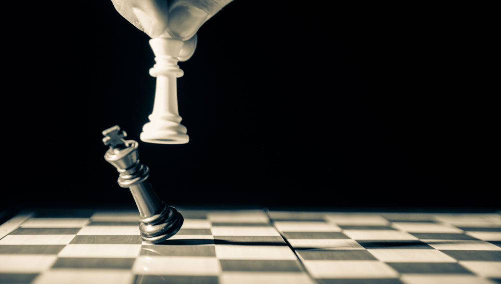 Chess: White king knocking over black king (Photo by GR Stocks on Unsplash)