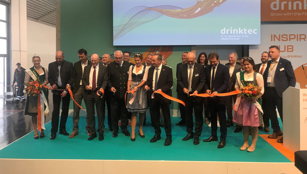 People cutting a ribbon at the opening of drinktec 2022