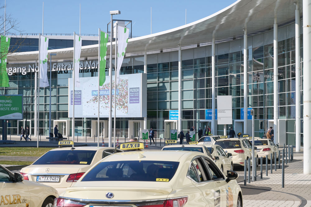 Exterior view of the entrance to the Cologne Exhibition Center, with Filtech 2022 poster and logo (Source: Filtech Exhibitions Germany)