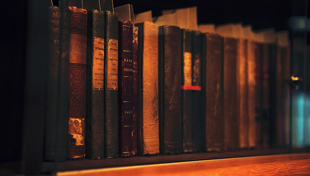 Close-up of vintage books on a shelf (Photo: Leiada Krozjhen on Unsplash)