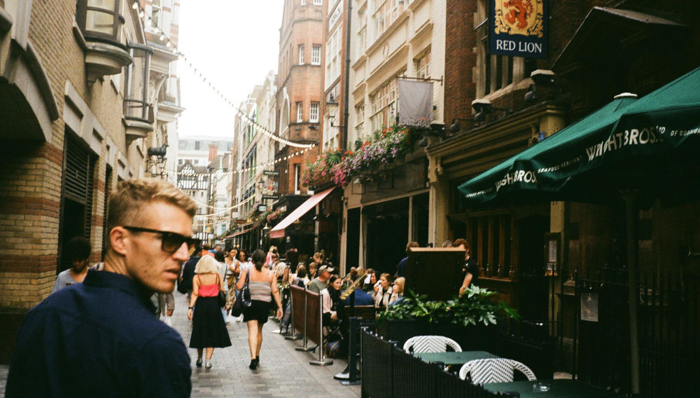 Little street with young man wearing sunglasses (Image: Zach Rowlandson on Unsplash)