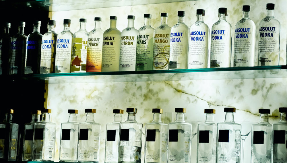 Absolut bottles in a row (Photo: Carlos Irineu da Costa on Unsplash)