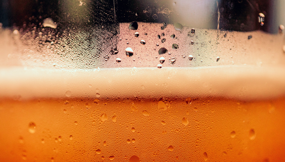 close-up of a beer in a glass (Photo: Timothy Dykes, Unsplash)