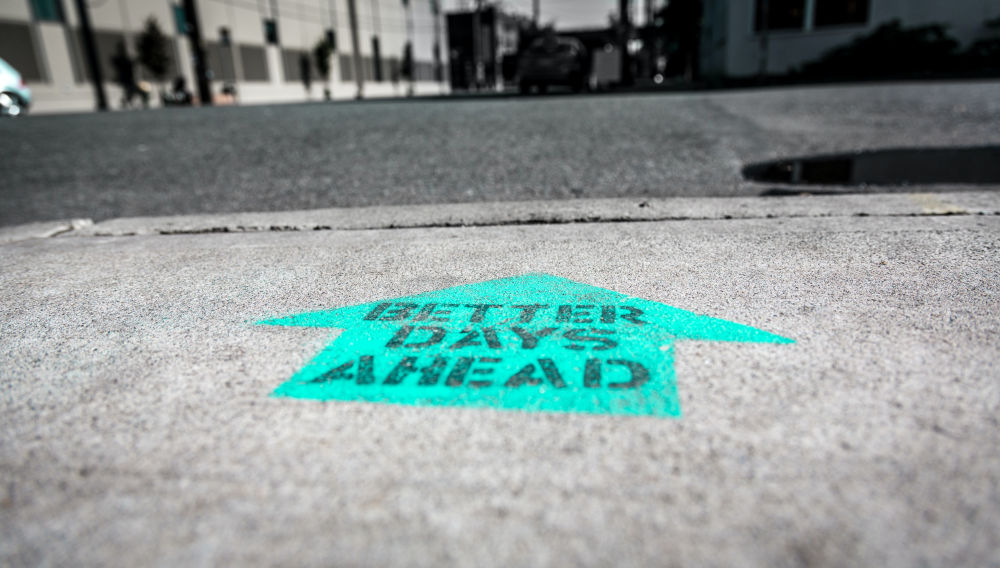 Sign on the floor saying “better days ahead” (Photo by Ian Taylor on Unsplash)