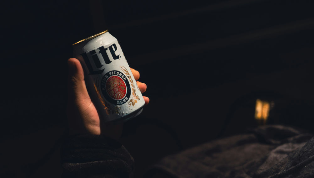 Hand holding a beer can (photo: Marty O'Neill on Unsplash)