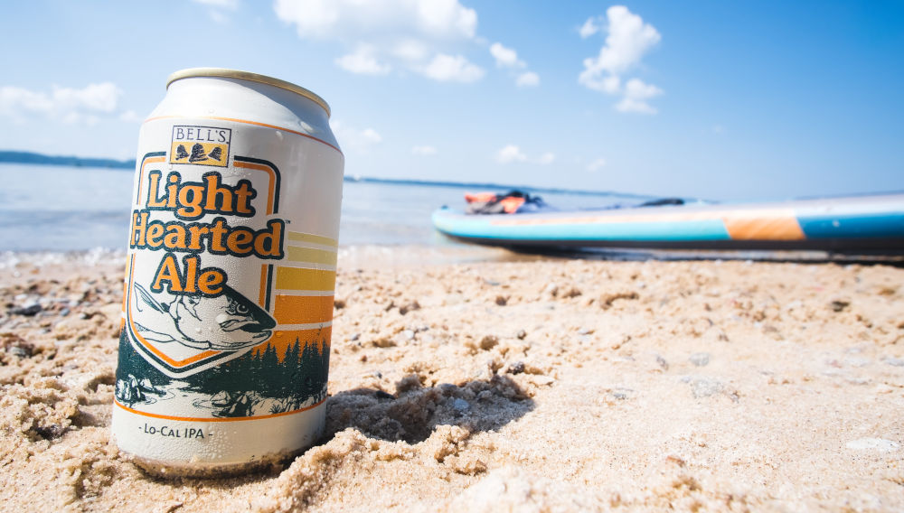 Can of Bell’s Light Hearted Ale on a beach (Photo by Cyrus Crossan on Unsplash)