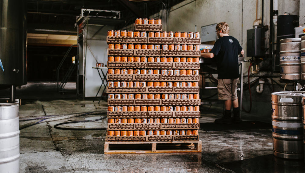 Rack with piled can crates (Photo by Wade Austin Ellis on Unsplash)