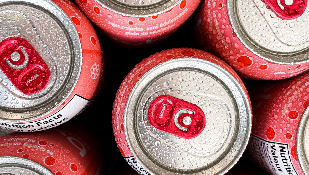 Red and white cans from above (Photo by James Yarema on Unsplash)