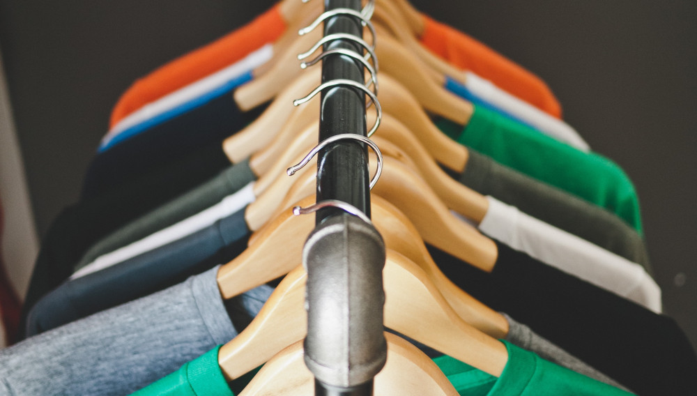 T-shirts on a clothes rack (Photo: Jeff Sheldon, Unsplash)