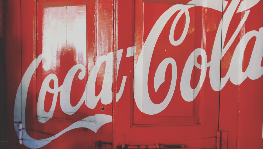 Coca Cola lable on a truck door (Photo: Yogesh Pedamkar, Unsplash)