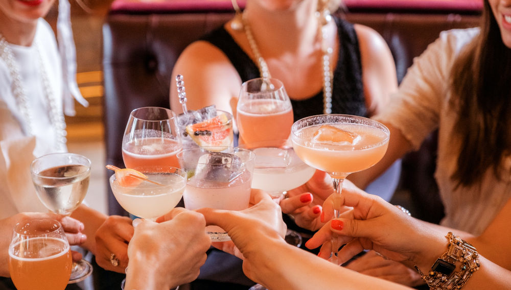 A group of people toasting with sparkling drinks (Photo: Helena Yankovska on Unsplash)