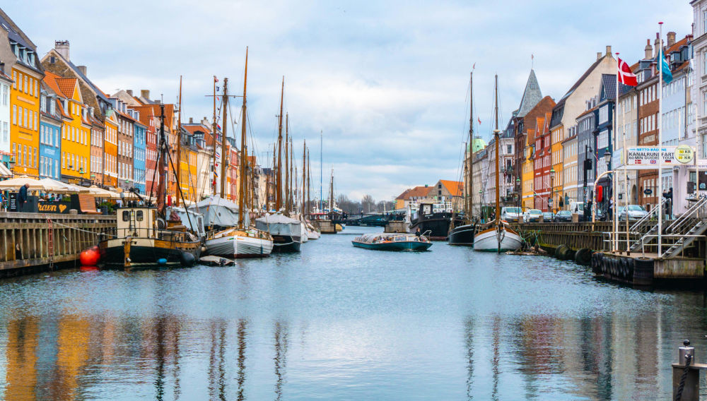 Boats on a canal in Denmark (Photo: Ava Coploff on Unsplash)