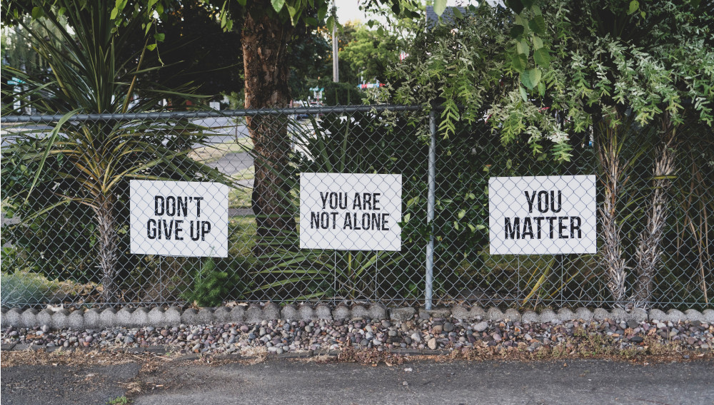 encouraging signs along the street (Photo: Dan Meyers, Unsplash)