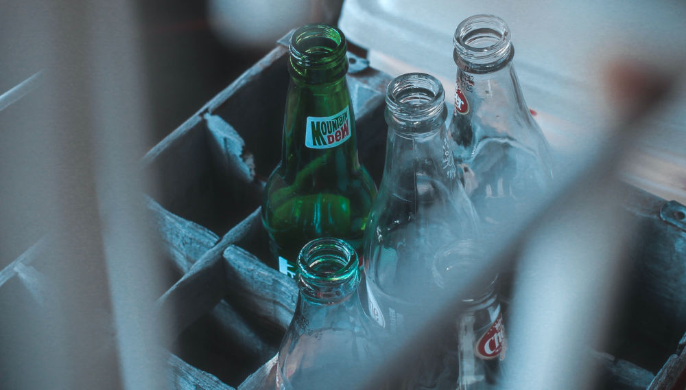 Glass soda bottles in crate (Photo by Josh McLain on Unsplash)