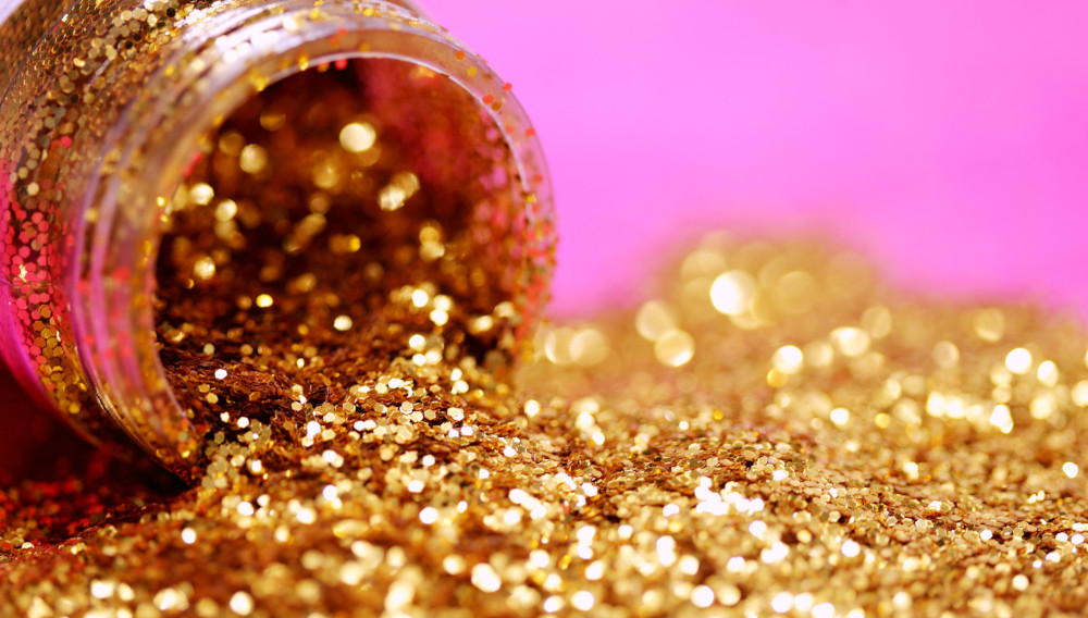 Gold glitter spilling out of a jar (Photo by Sharon McCutcheon on Unsplash)