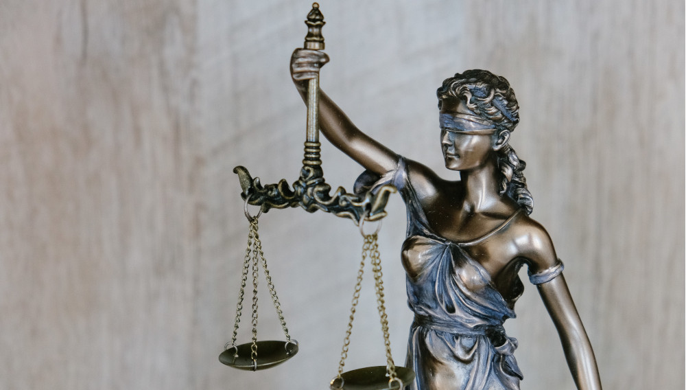 Lady Justice Figure (Photo by Tingey Injury Law Firm on Unsplash)