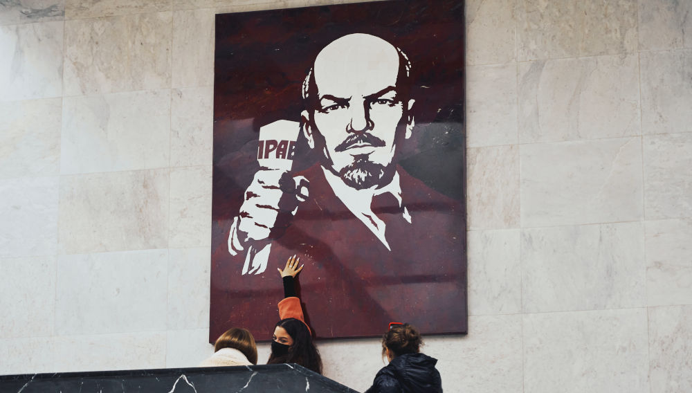 Black and white Lenin poster on wall (Photo by Maxim Tolchinskiy on Unsplash)