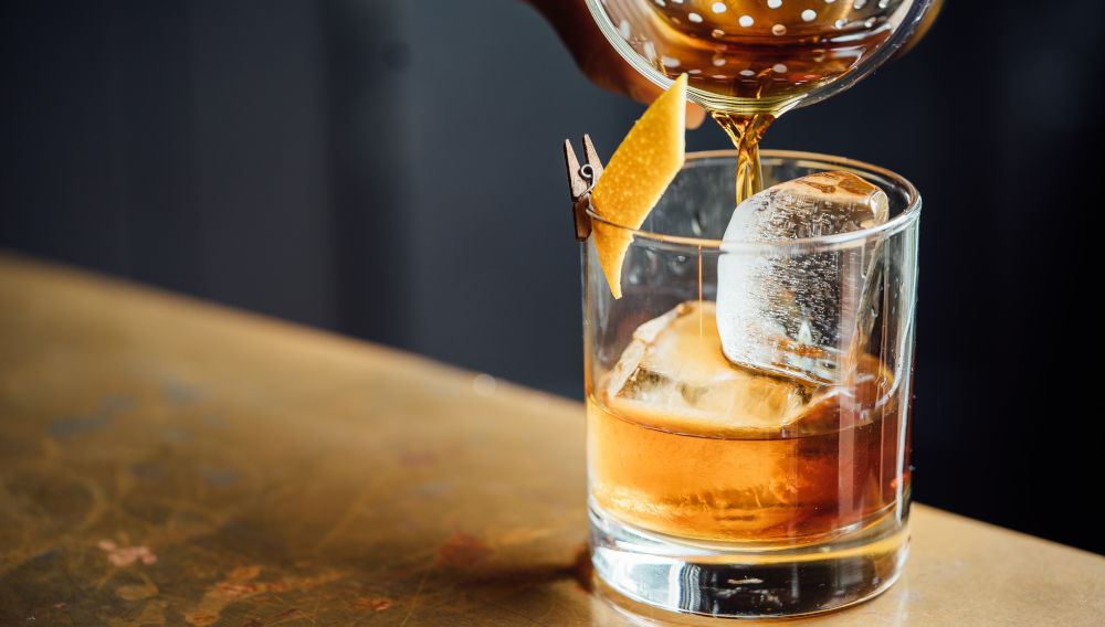 Liquor is poured into a shot glas (Photo by Adam Jaime on Unsplash)