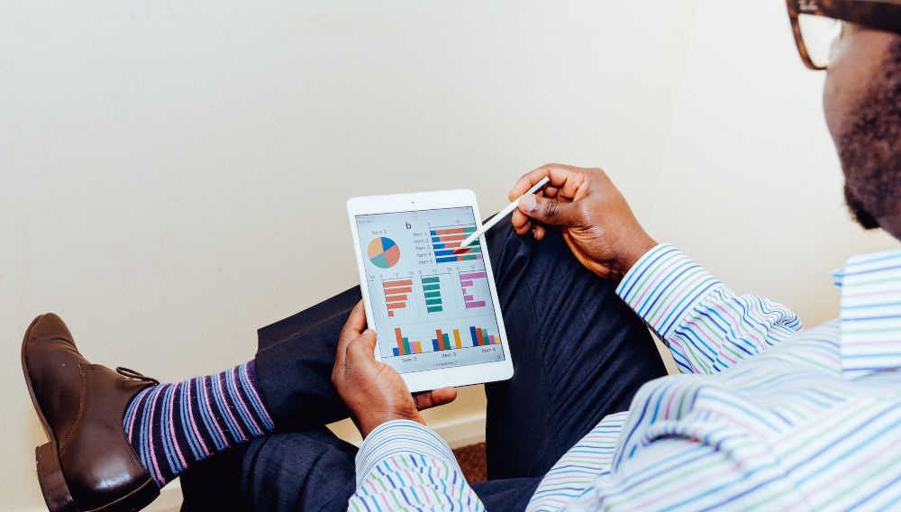 Man looking at marketing analytics (Photo: Adeolu Eletu on Unsplash)