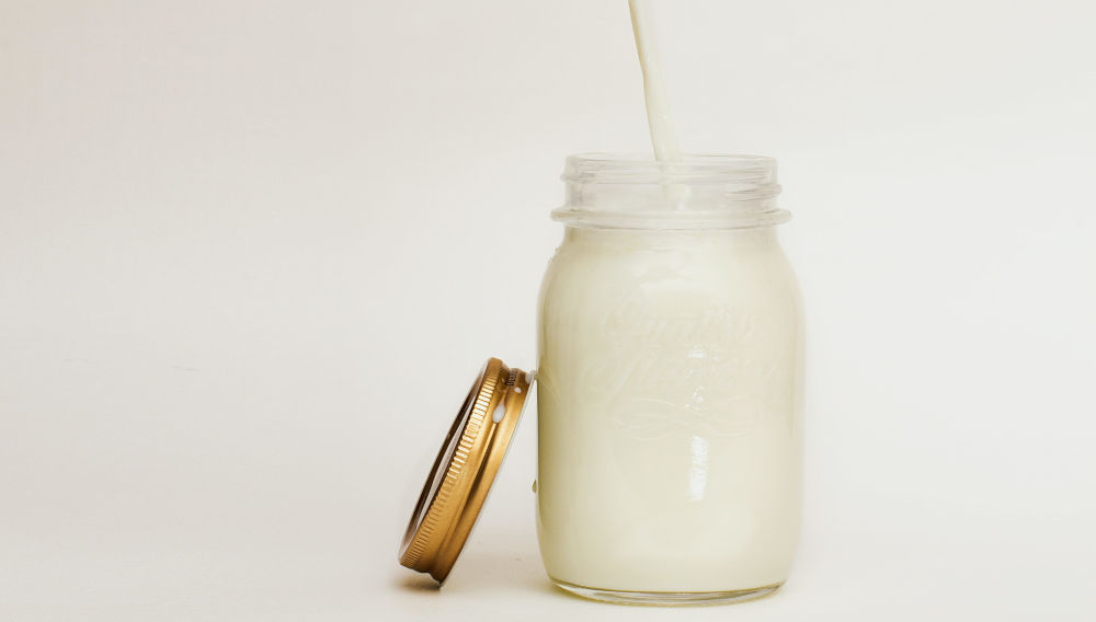 Mason jar filled with white liquid (Photo by Nikolai Chernichenko on Unsplash)