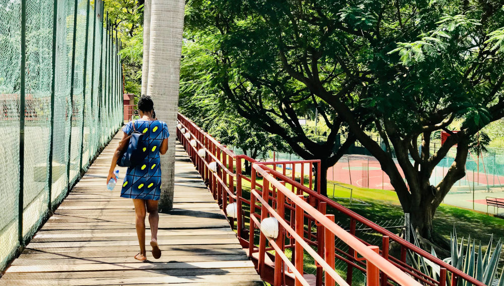 Person walking a bridge in Nigeria (Photo by Obinna Okerekeocha on Unsplash)