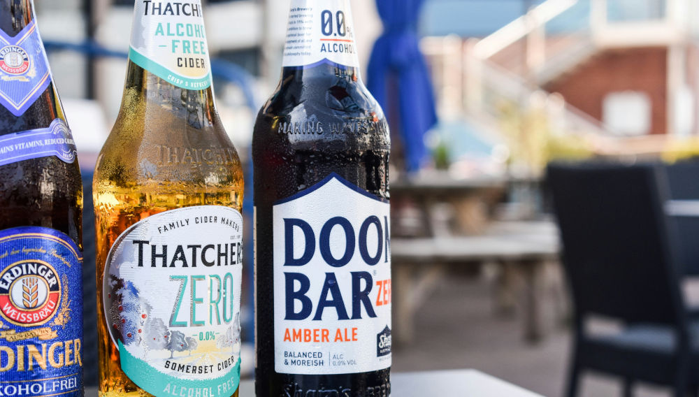 Three bottles of different non-alcoholic beers on a table, close-up (Photo: Amy Vann on Unsplash)