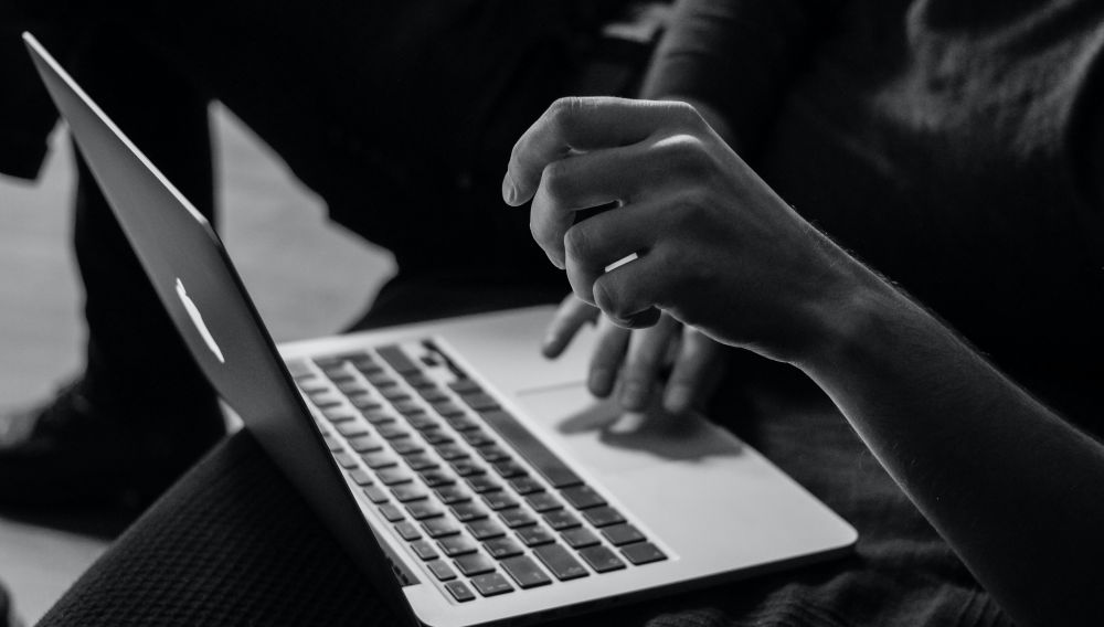 Person using a notebook (Photo: Sergey Zolkin on Unsplash)