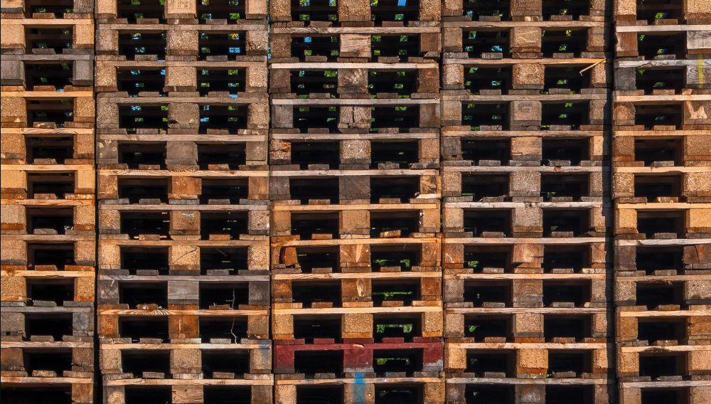 Big pile of pallets (Photo by Lucas van Oort on Unsplash)