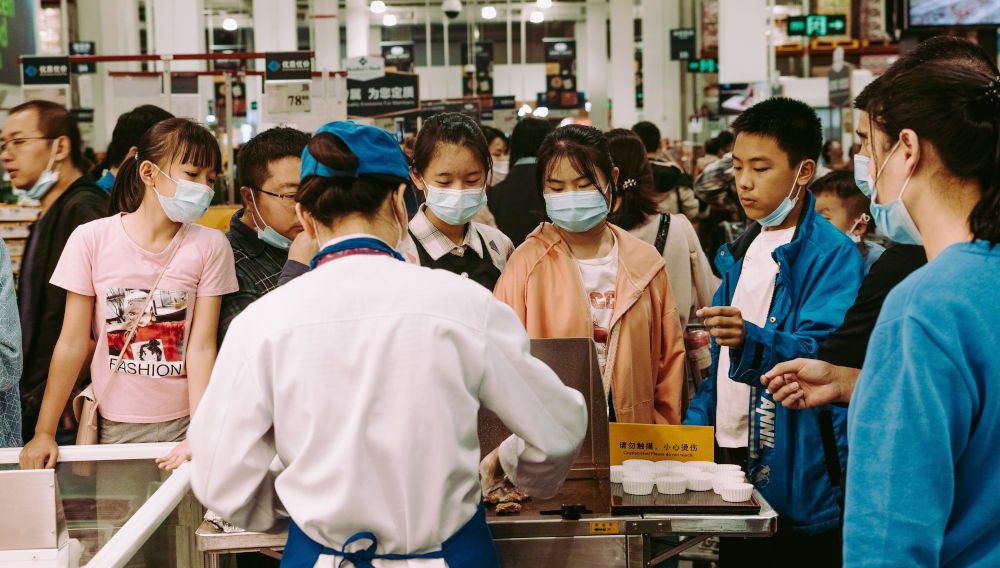 A group of people in front of a table at a Sam's club during the 2020 Covid-19 pandemic in Shenzhen, China (Photo by Joshua Fernandez on Unsplash)