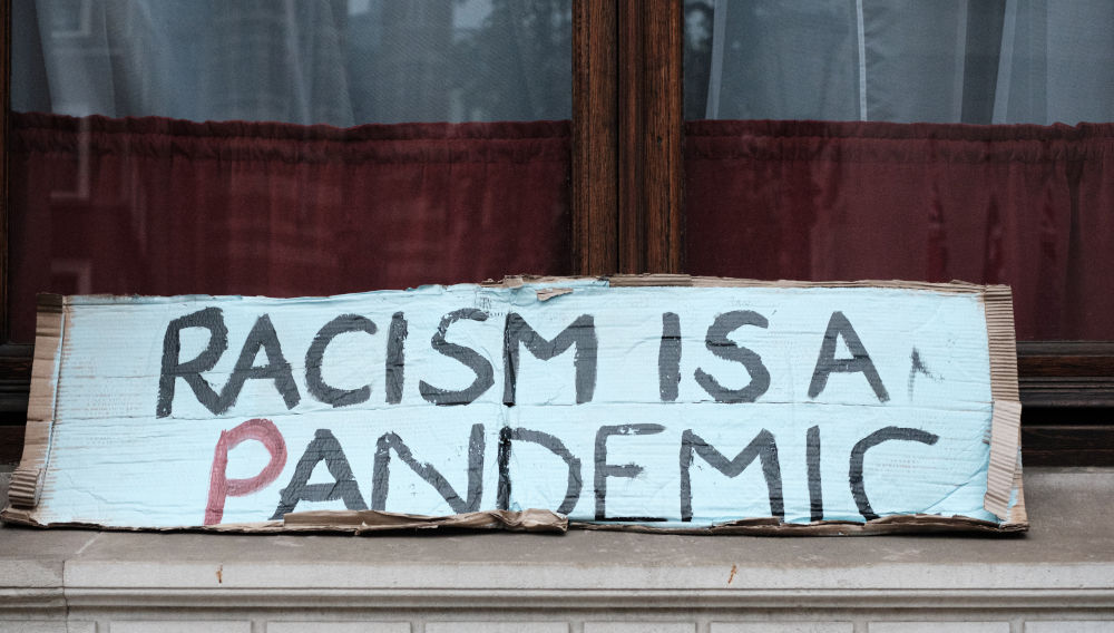 Sign with Anti-racism-inscription (Photo: Ehimetalor Akhere Unuabona on Unsplash)