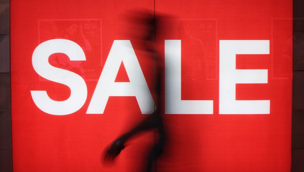 Red sign with white letters saying: SALE (Source: Justin Lim on Unsplash)