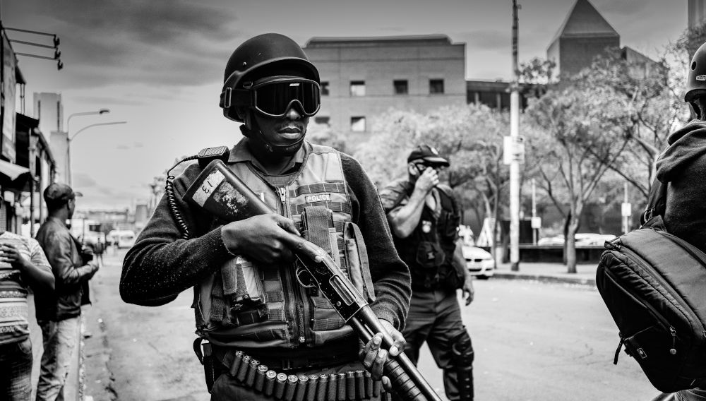 Soldier carrying rifle (Photo by Pawel Janiak on Unsplash)