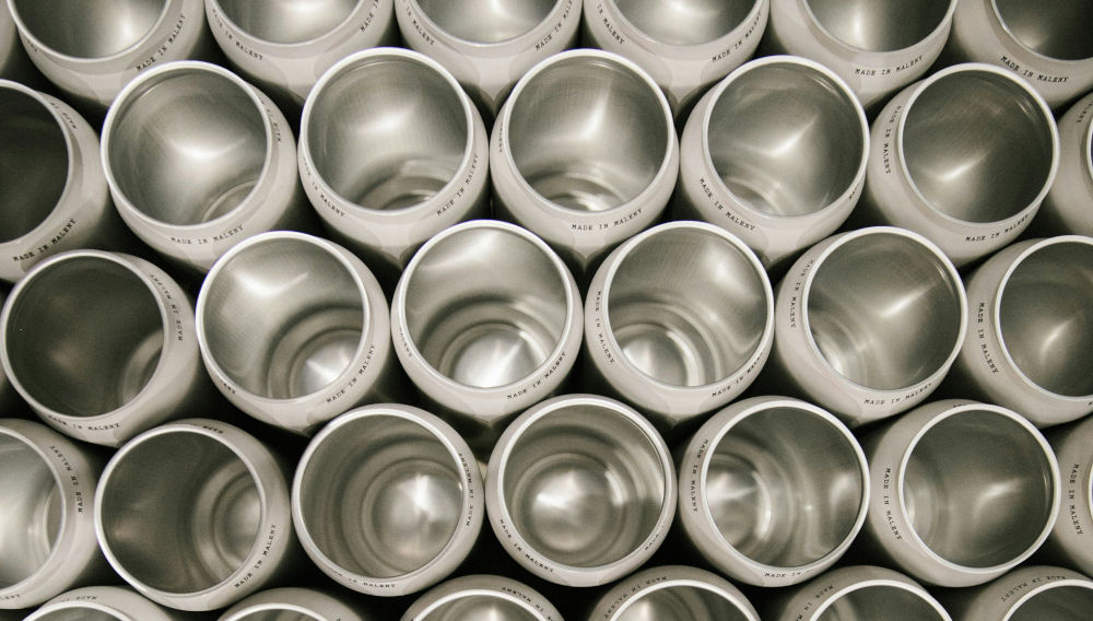 Stainless steel pots with the inscription “Made in Maleny” pictured from above (Photo: Toby Stodart on Unsplash)