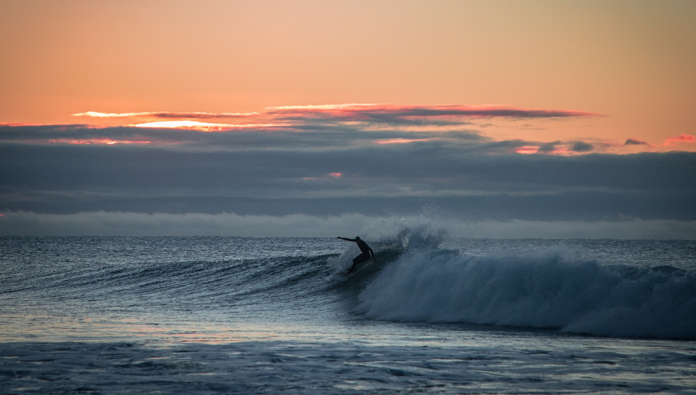 surfer with sunset in the backround (Photo: Jamie Davies, Unsplash)
