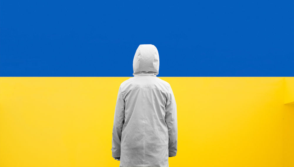 Person standing in front of a blue and yellow wall (Photo by Daniele Franchi on Unsplash)