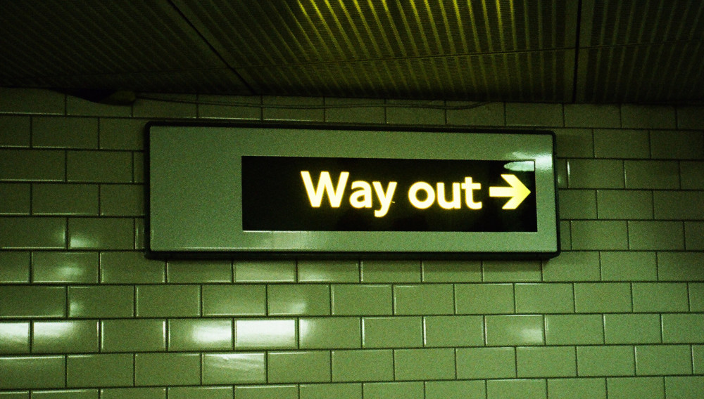 Way out sign in a subway station (Photo: Jakob Cotton, Unsplash)