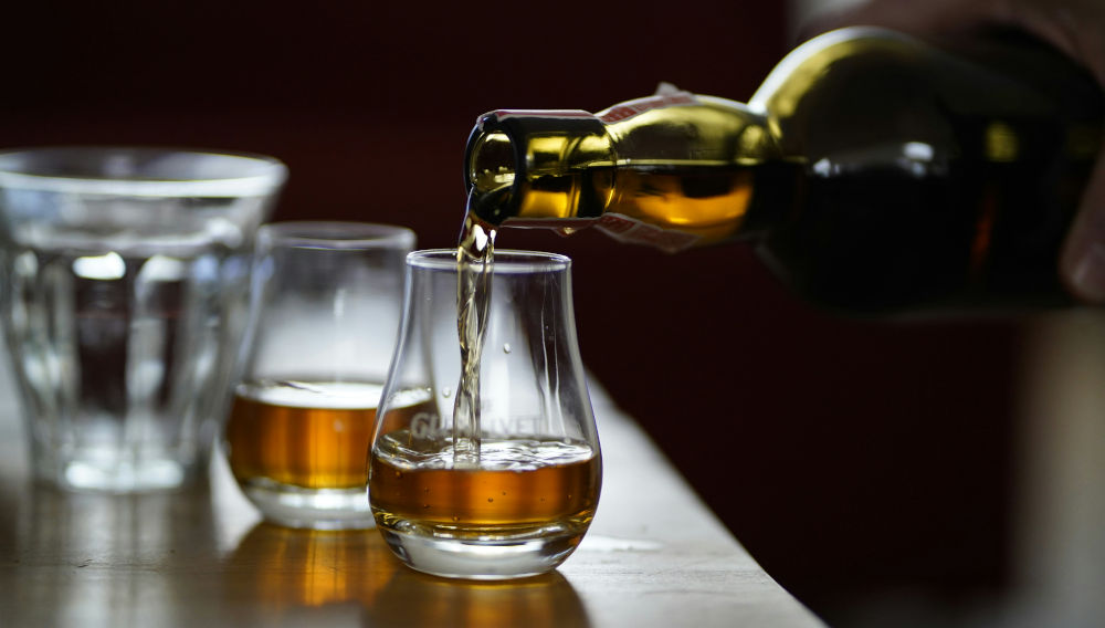 Whisky being poured into a glass from a bottle (Photo: Dylan de Jonge on Unsplash)