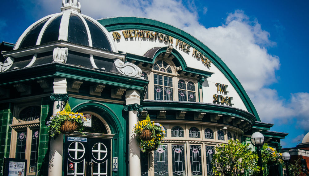 White and green Wetherspoon pub (Photo by Greg Willson on Unsplash)