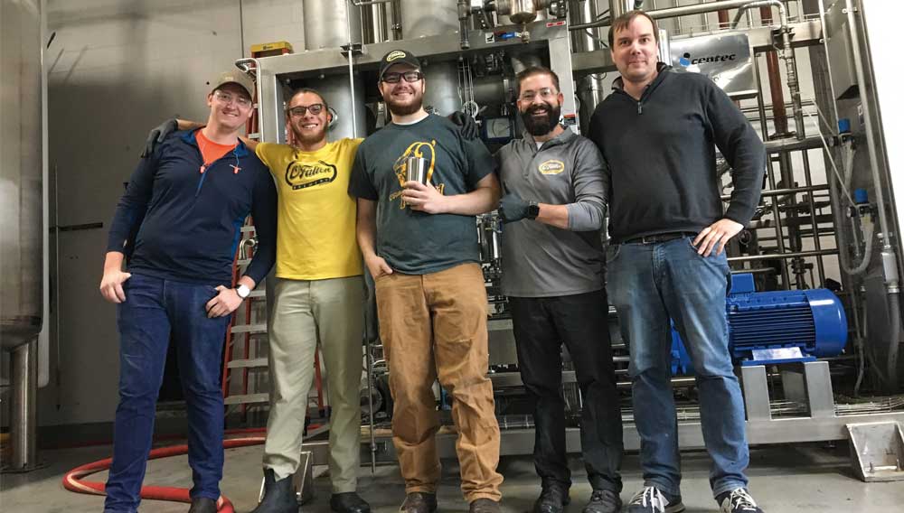 From the left: Devon Verhoff, Trey Chatman, Luke Backer, Brian Owens of O’Fallon Brewery and Manuel Kullick of Centec in front of the dealcoholization colum (Photo: Wellbeing Brewing Company) 