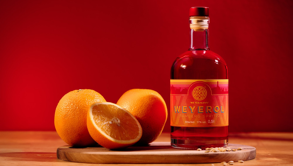 Flasche Weyermann Weyerol auf einem Tablett mit Orangen